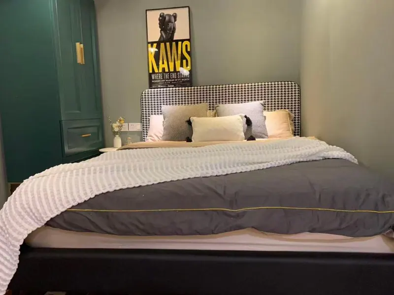 Bedroom with queen bed and houndstooth headboard